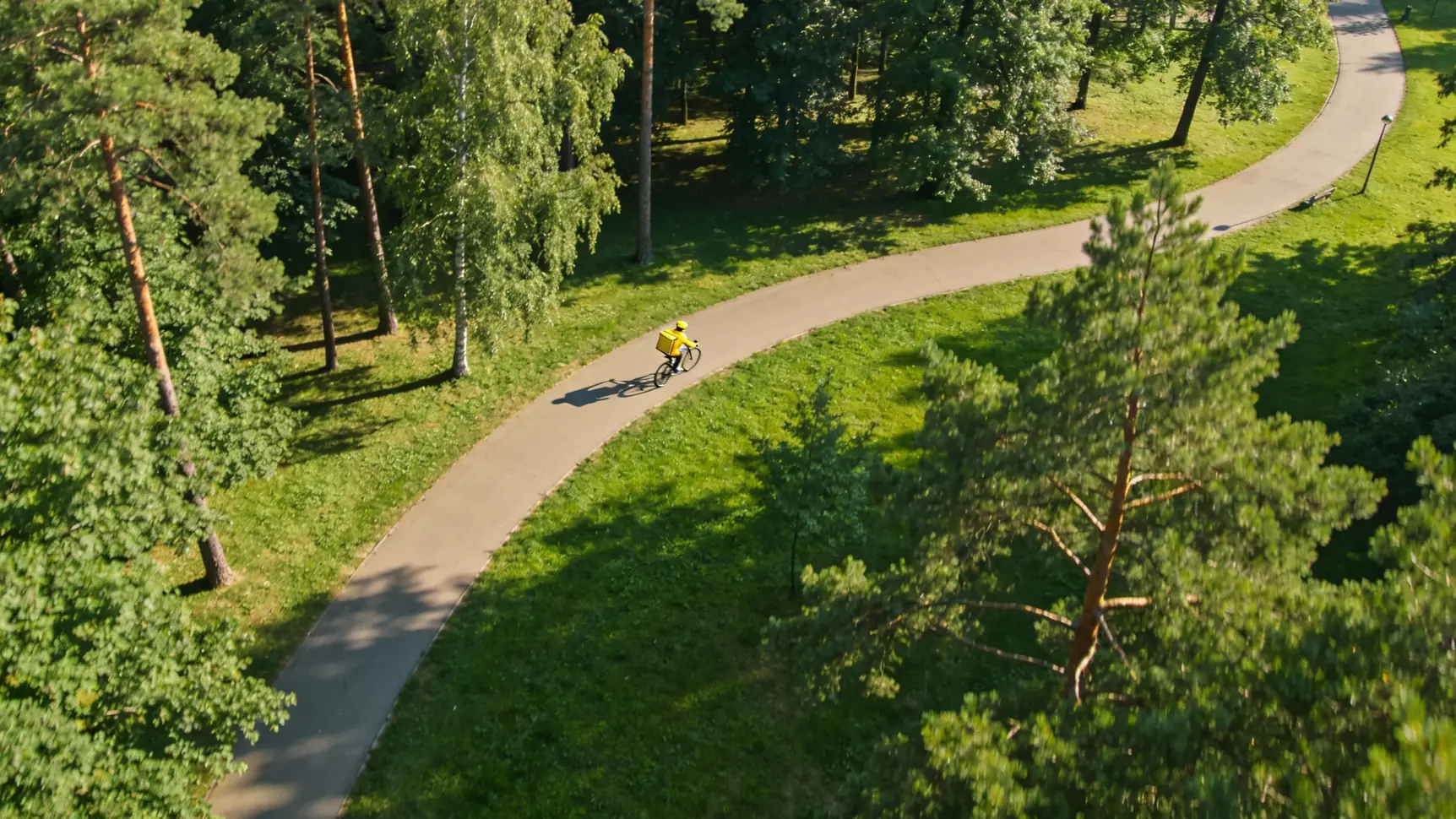 Процесс передачи заказа курьером клиенту у входа в современный жилой комплекс.